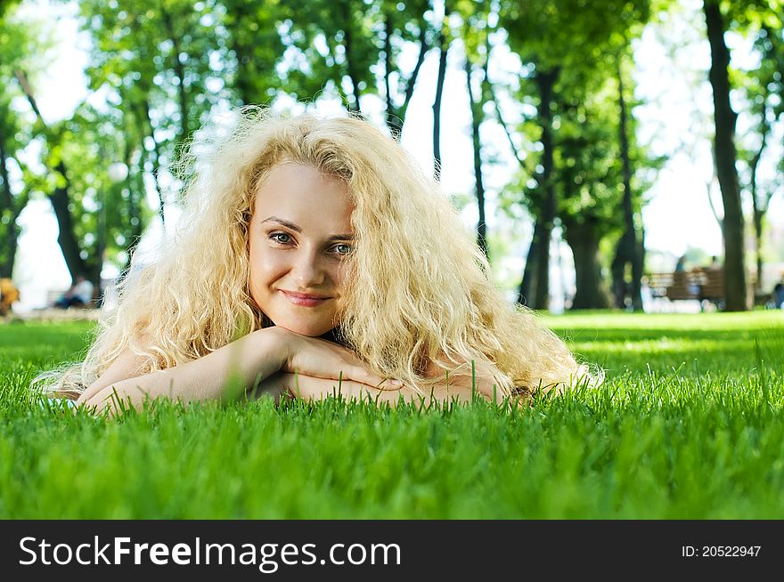Beautiful Young Woman lying on the green grass. Beautiful Young Woman lying on the green grass