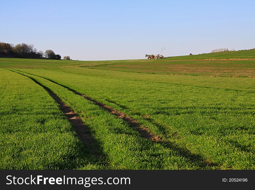 Rural scene of a tractor working the land. Rural scene of a tractor working the land