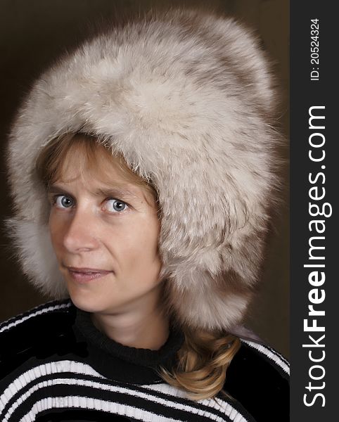 The young woman in a fluffy fur cap.