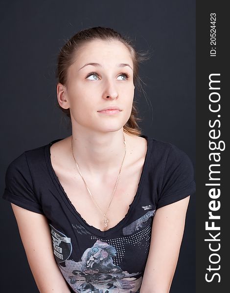 Pensive dreamy girl looks up studio photography