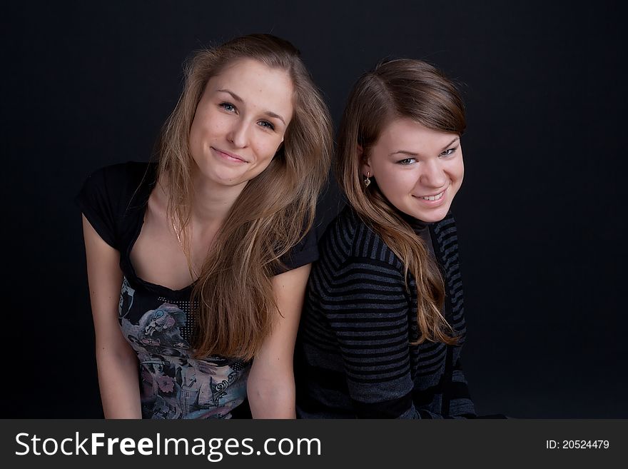 Two friends talking and smiling studio shot
