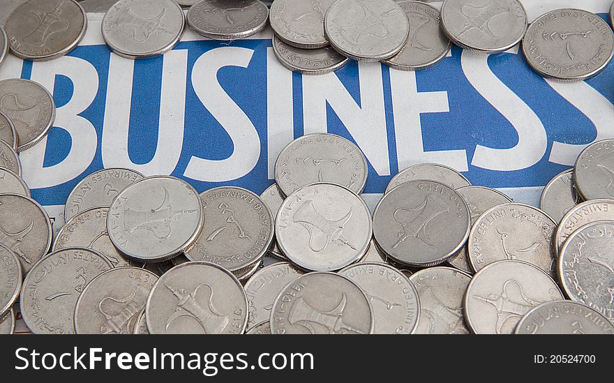 Coins on the business newspaper as background