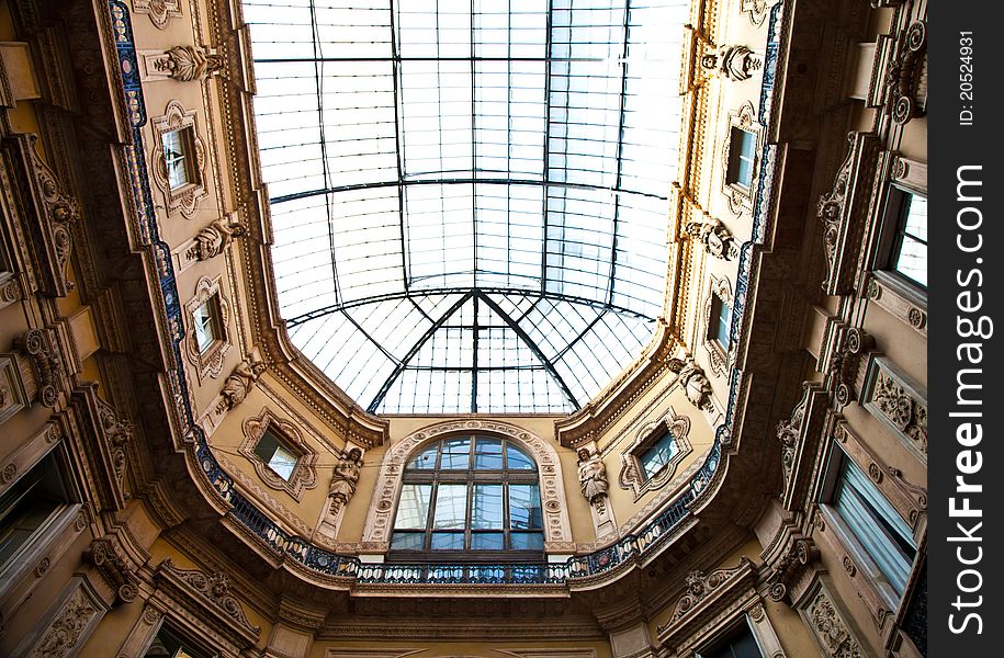 The Galleria Vittorio Emanuele II is a covered double arcade formed of two glass-vaulted arcades at right angles intersecting in an octagon, prominently sited on the northern side of the Piazza del Duomo in Milan. The Galleria Vittorio Emanuele II is a covered double arcade formed of two glass-vaulted arcades at right angles intersecting in an octagon, prominently sited on the northern side of the Piazza del Duomo in Milan.