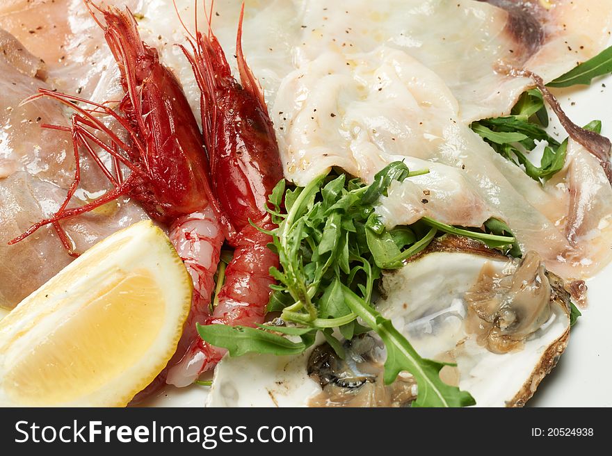 Seafood appetizer with oyster, shrimp and arugula