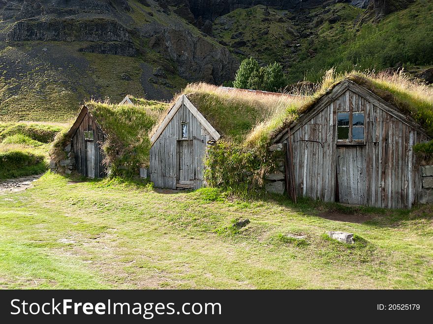 Small wooden houses with grass on the roof in iceland