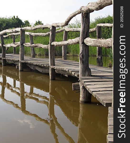 Wood Bridge reflected in water. Wood Bridge reflected in water