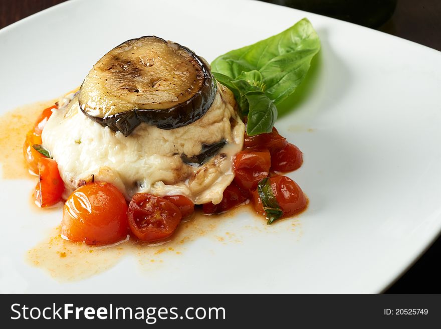 Pie of eggplants seasoned with tomato and cheese