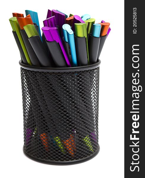 Ballpoint pens in pencil holders on white