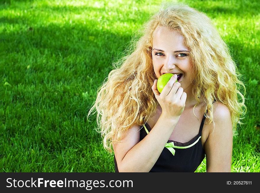 Portrait of young girl eating green apple