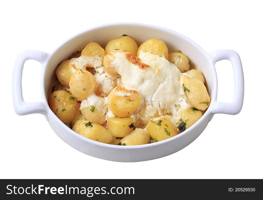 Potatoes and cream baked in a casserole dish - cut out on white