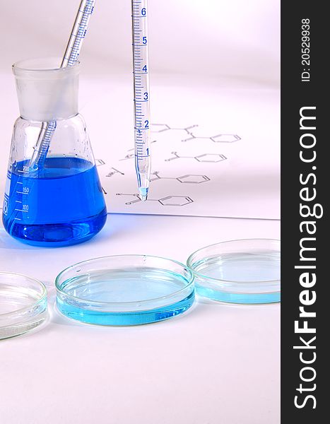 Laboratory glassware with blue chemical close up