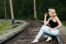 Sexy Woman Seating On Railway And Smoking Cigaret Royalty Free Stock Image