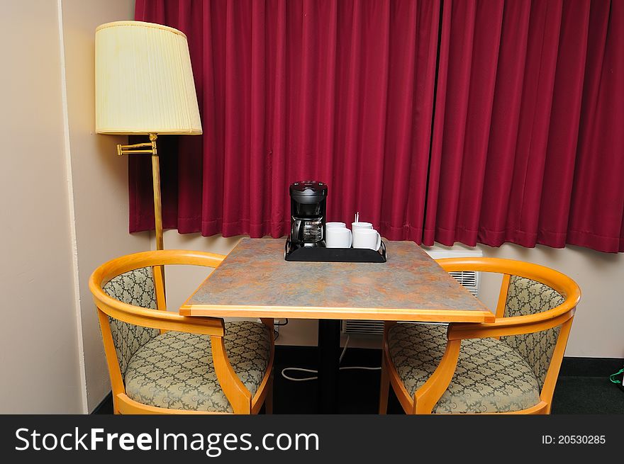 Table and chairs with coffee making equipment for a break. Table and chairs with coffee making equipment for a break.