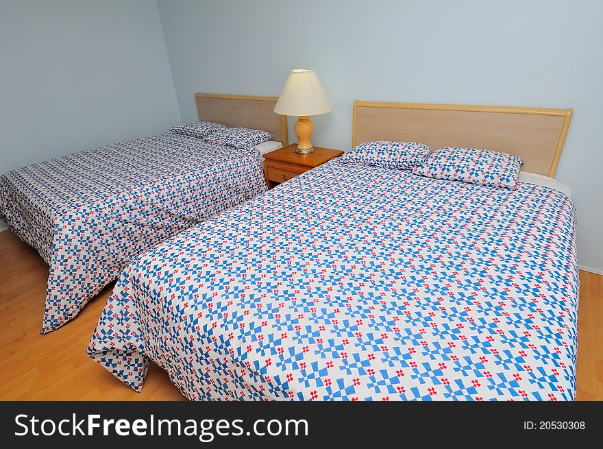Interior view of simple room with double beds.