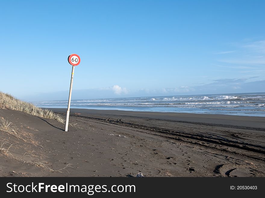 Speed sign on the ocean beach.Black sand beach.West Coast of North Island.New Zealand