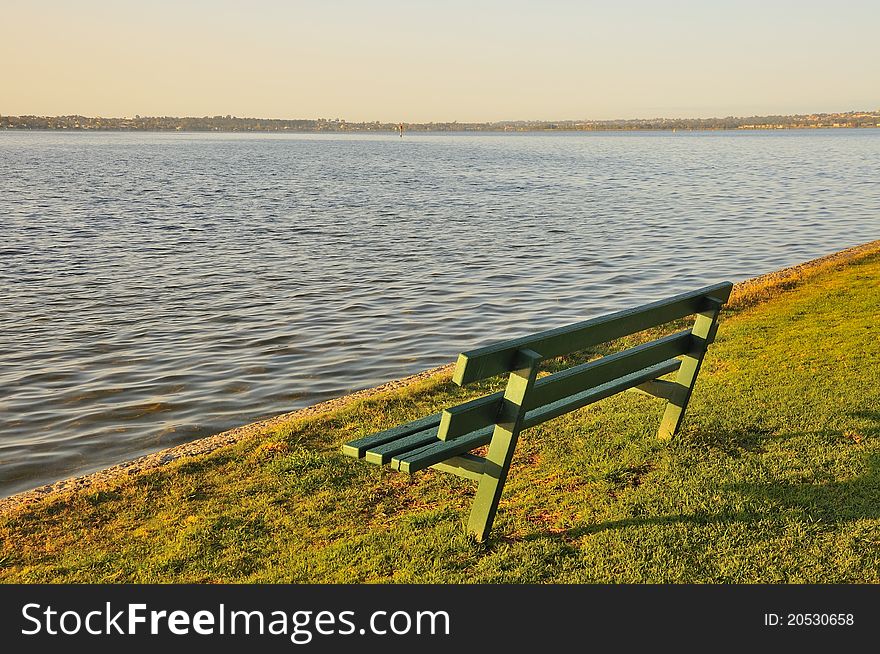 Wooden bench in a park overlooking the sea. Wooden bench in a park overlooking the sea.