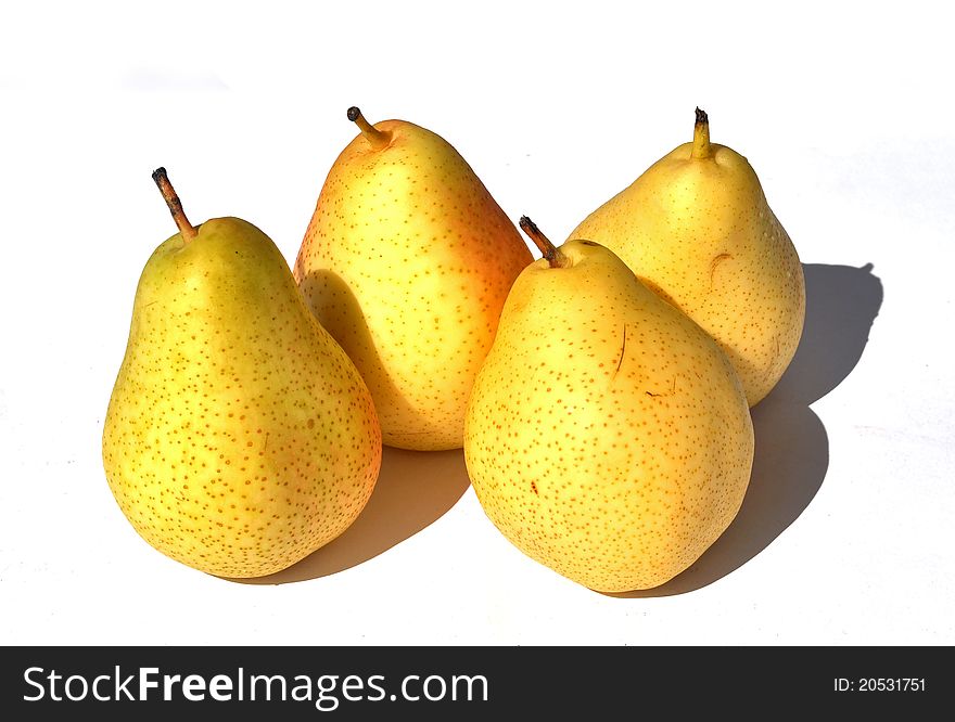 Four yellow pears with their shadow on a white background. Four yellow pears with their shadow on a white background