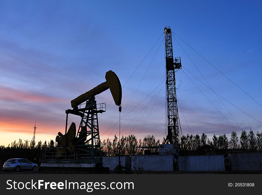 Oil pump silhouette against a bright blue sky