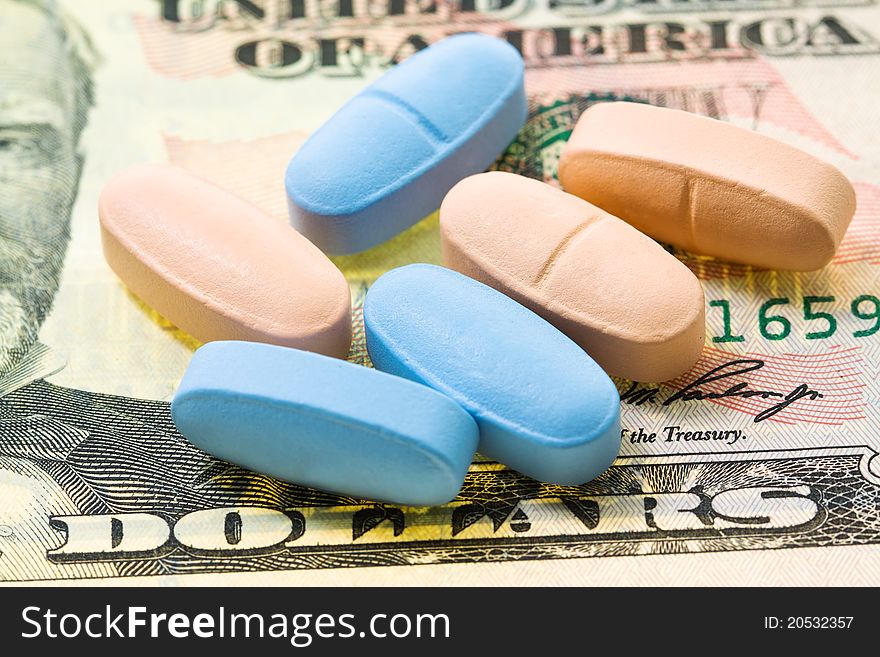 The American dollars on which multi-colored tablets lie. The American dollars on which multi-colored tablets lie