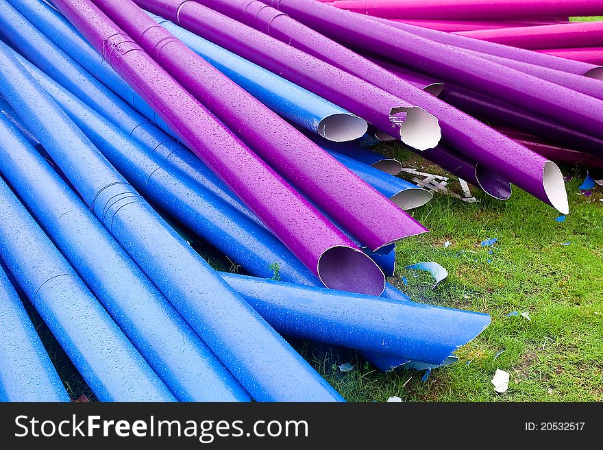 Many colorful pipes for decoration on the grass