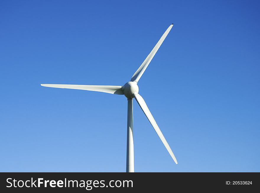 Wind turbine against a blue sky