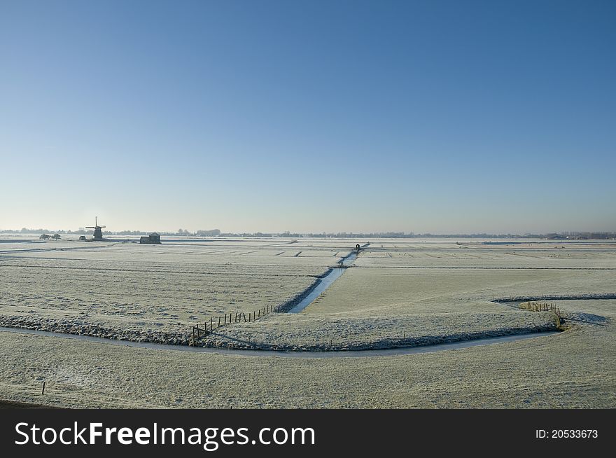 A windmill in a dutch winter landscape