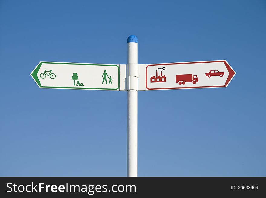 Environmental signpost or road sign showing green arrow to the left and red arrow to the right. Environmental concept image. Environmental signpost or road sign showing green arrow to the left and red arrow to the right. Environmental concept image.