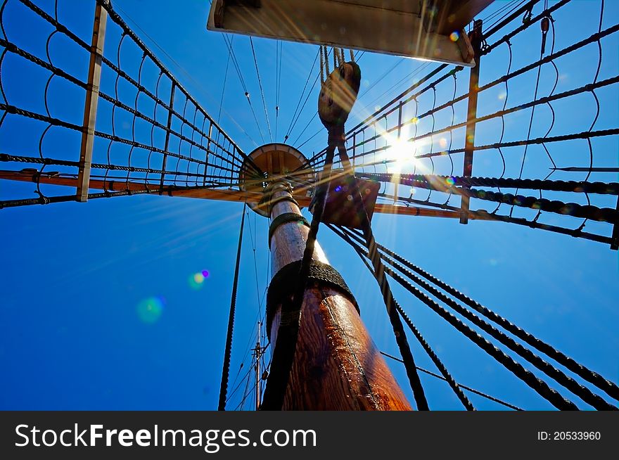 View of mast and rigging on the sail ship against the deep blue summer sky. View of mast and rigging on the sail ship against the deep blue summer sky.