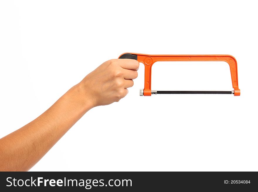 A female hand holding an orange hack saw on white isolated background