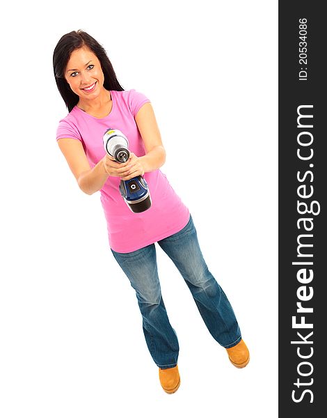 Young female dressed in pink top and blue jeans holding a cordless electric drill on isolated white background. Young female dressed in pink top and blue jeans holding a cordless electric drill on isolated white background.