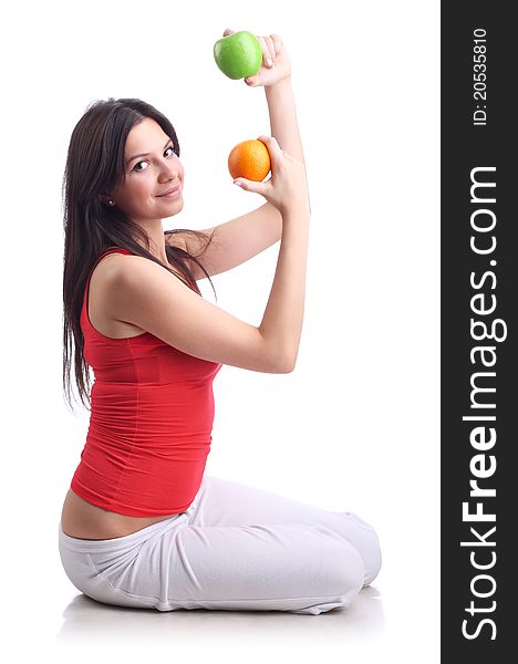 Young woman with apple and orange. Isolated