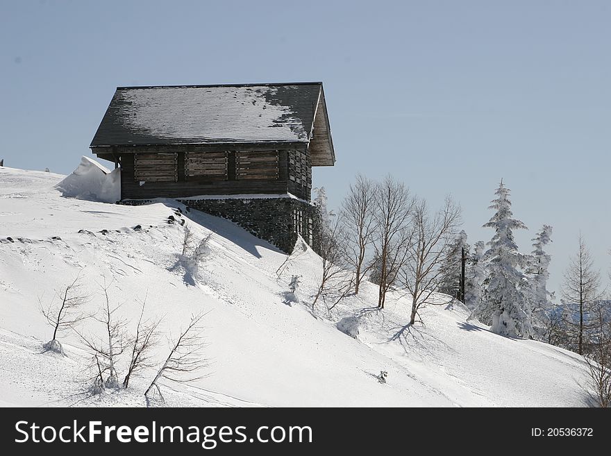 Wooden snow hut in snow mountain