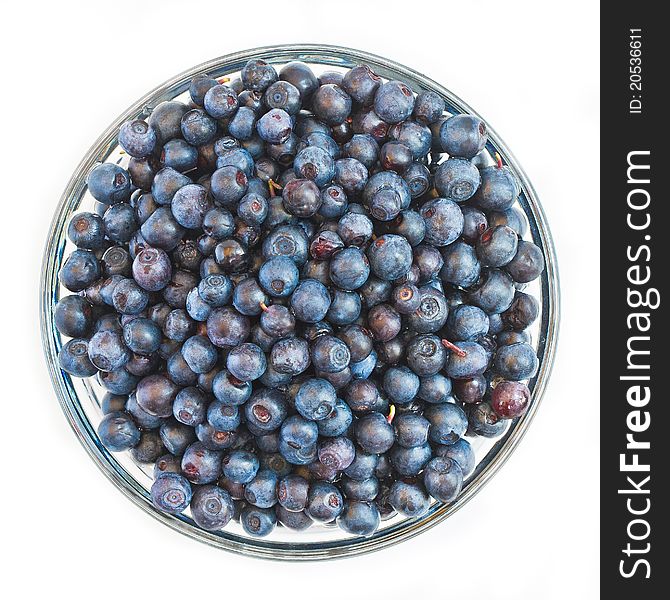 Fresh blueberries in a glass bowl isolated