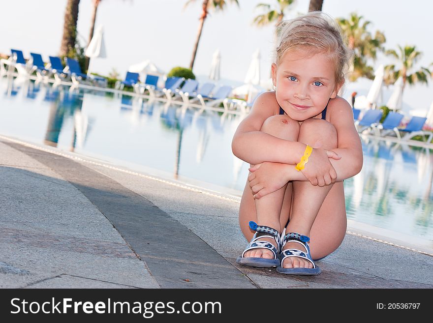 Beautiful girl posing at the swimming pool. Beautiful girl posing at the swimming pool