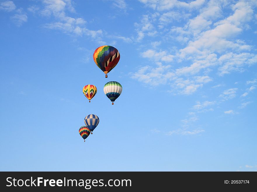 Five hot air balloons in the sky