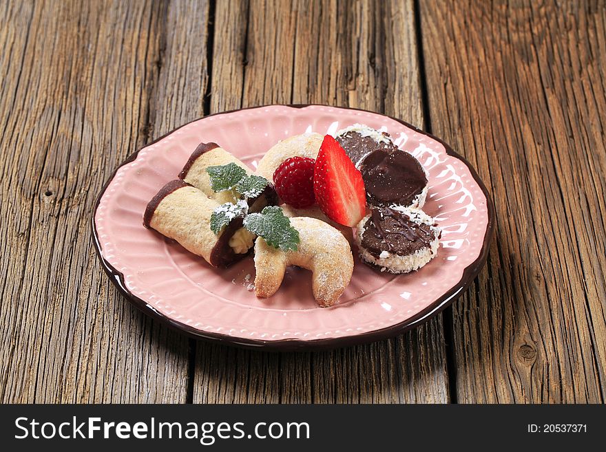 Variety of cookies on a pink plate
