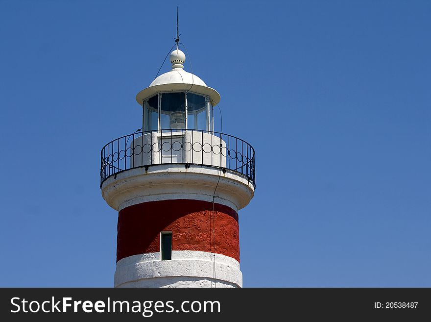 The tower and it`s light of the red nad white lighthouse on cape Ostro in Kraljevica. The tower and it`s light of the red nad white lighthouse on cape Ostro in Kraljevica