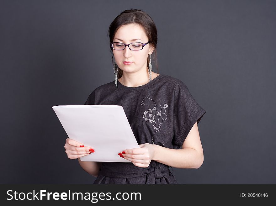 Businesswoman with documents in hand with glasses studio photography