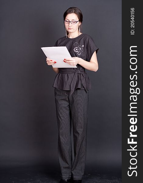 Businesswoman with documents in hand with glasses studio photography