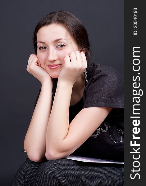 Portrait of a beautiful girl on a dark background studio photography