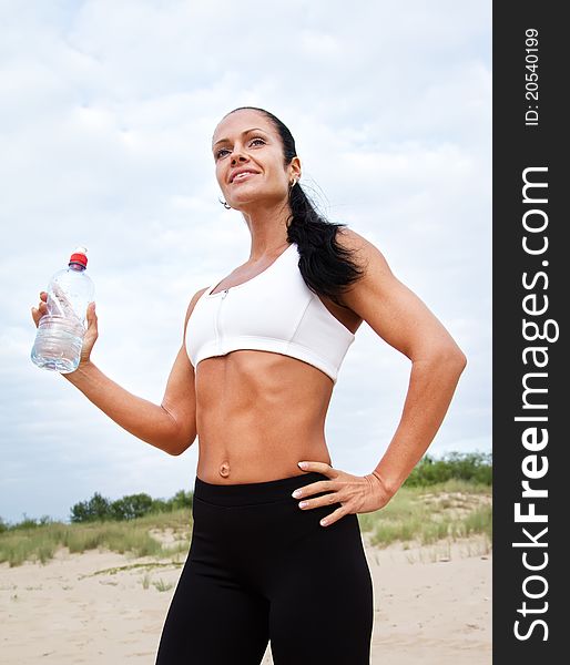 Sexy woman holding a bottle of water. Sexy woman holding a bottle of water