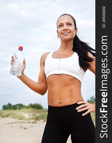 Beautiful fit girl drinking water after exercises. Beautiful fit girl drinking water after exercises