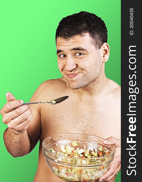 Young man eating salad close up shoot. Young man eating salad close up shoot