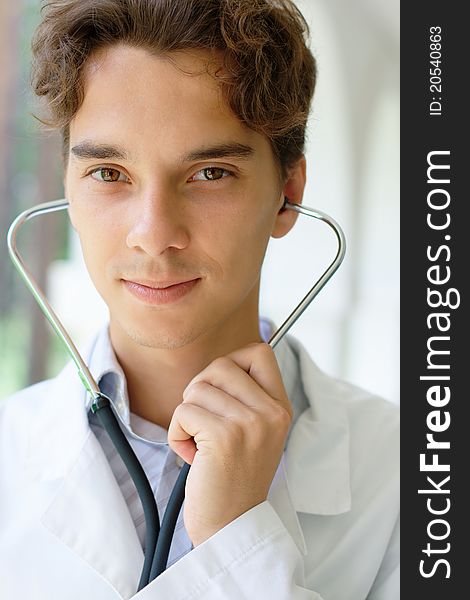 Close-up portrait of young smiling doctor