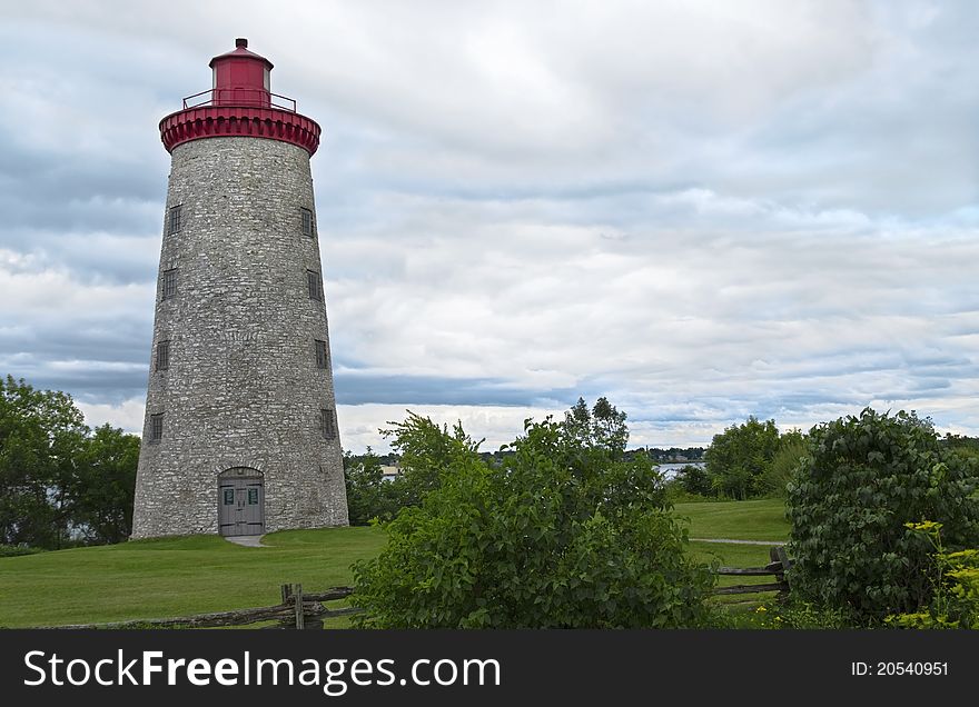 Country stone lighthouse surrounded by greenery. Country stone lighthouse surrounded by greenery.