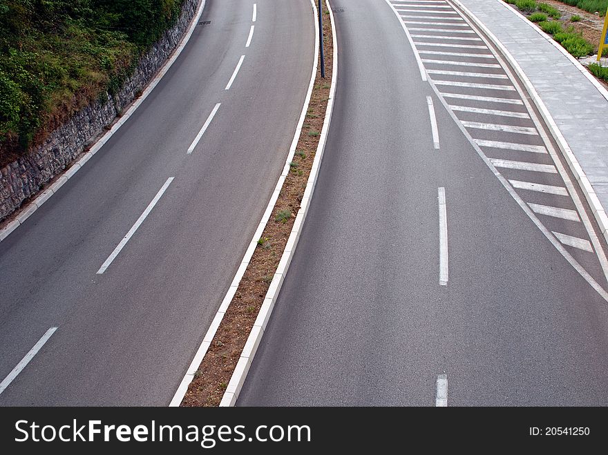 Empty asphalt marked curved road