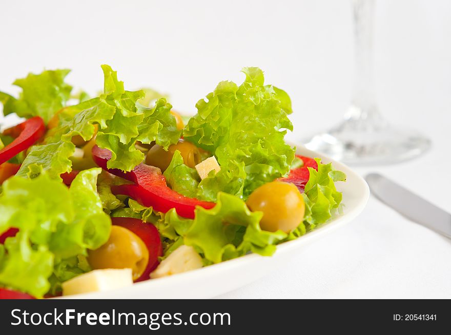 The picture shows a portion of salad. The picture shows a portion of salad