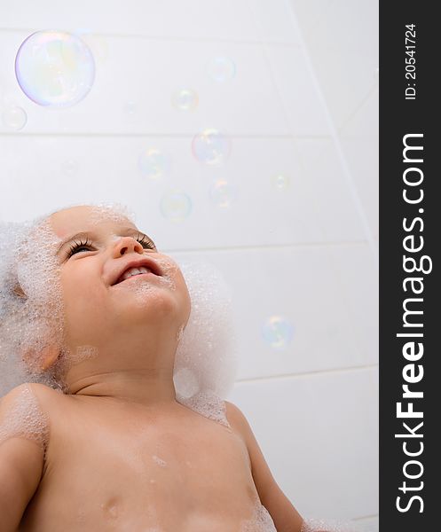 Little boy with foam on his head and bubbles. Little boy with foam on his head and bubbles