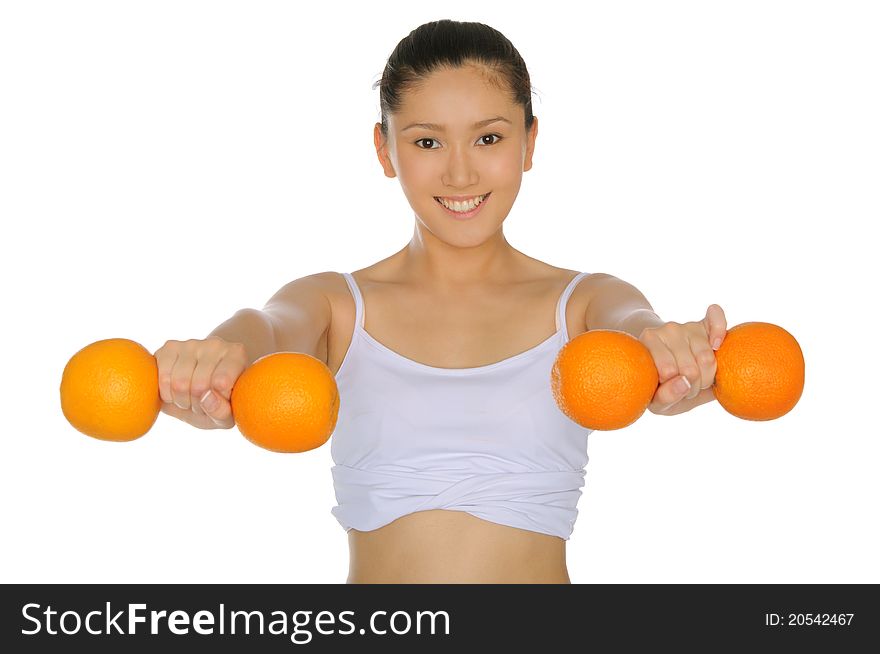 Asian woman engaged in fitness dumbbells of oranges isolated on white. Asian woman engaged in fitness dumbbells of oranges isolated on white