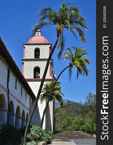 View of a Californian mission bell tower with mountains in the background